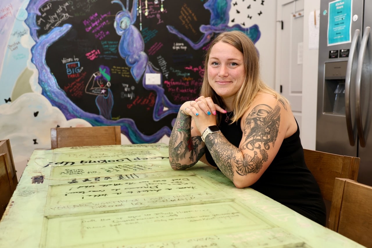 Mandie Knight sits in the shared kitchen at Sanctuary Night on Columbus’ west side.