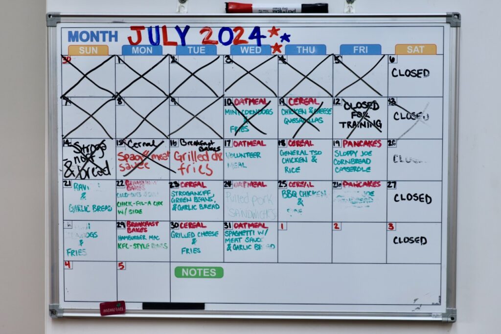 A calendar shows communal meal planning at Sanctuary Night.