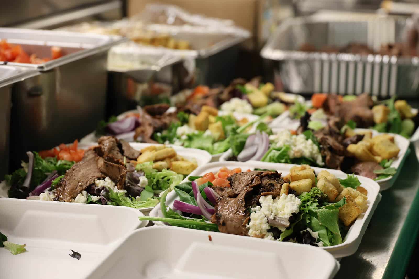 Prepared meal of lettuce, beef, onions, croutons, tomatoes and cheese
