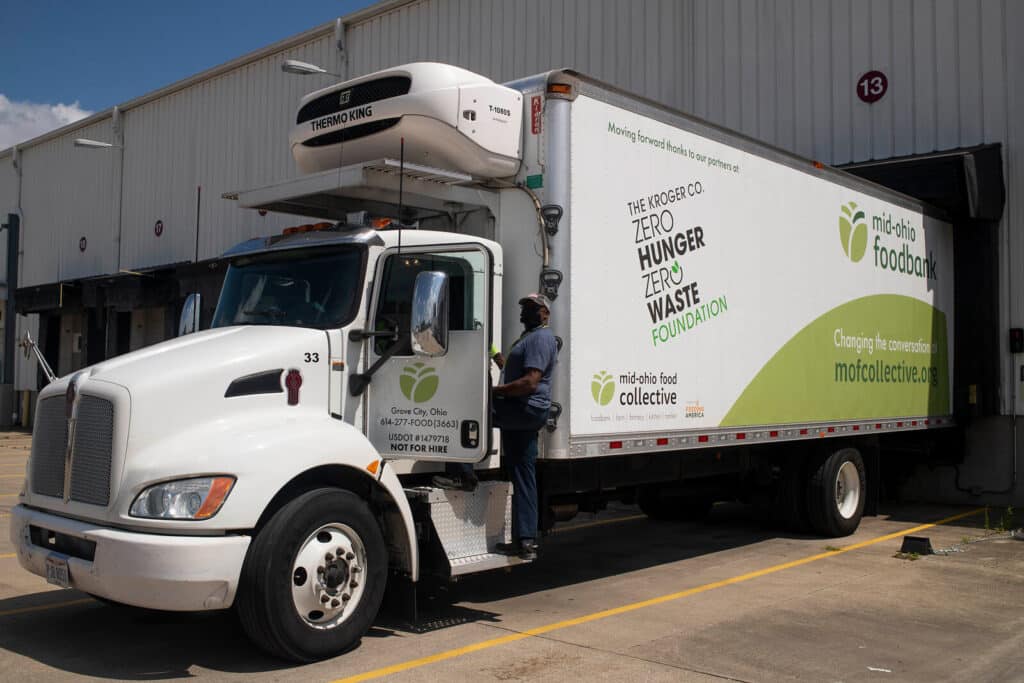 MOFC trucker stands by MOFC delivery truck