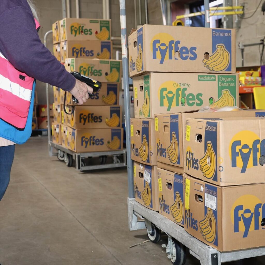Walmart employee scans boxes of bananas