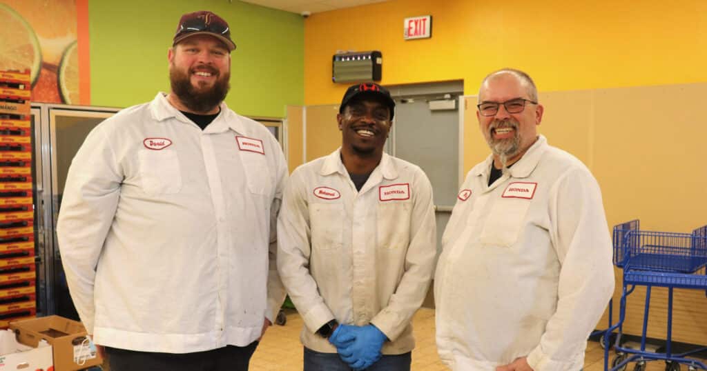 3 Honda employees pose in their white Honda shirts