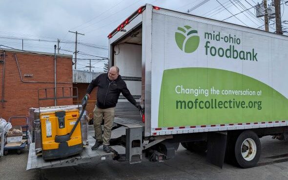 Mike unloads pallets of food from a MOFC truck