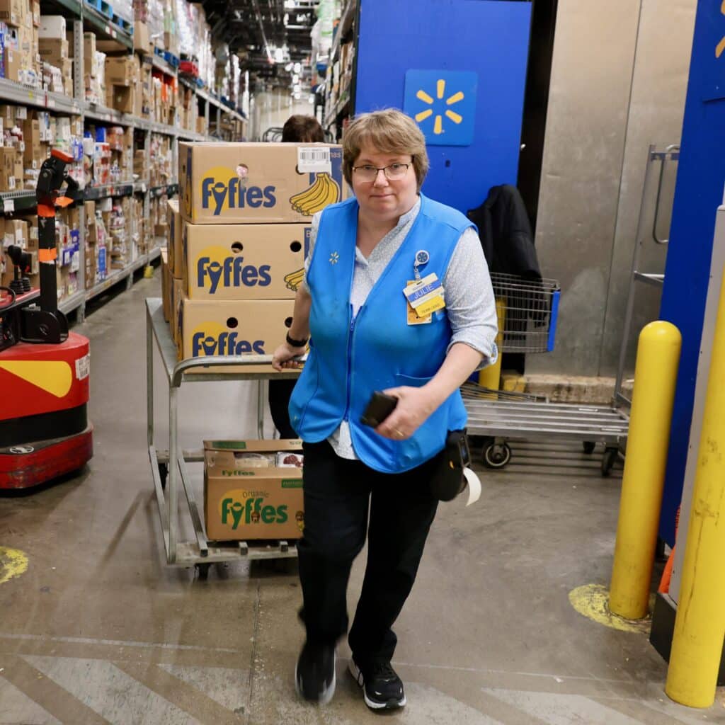 Julie Hughes, meat and produce lead at Walmart store #2725 in Lewis Center, Ohio, wheels the day's donations for Gladden Food Pantry to the store's truck dock. (March 2024)