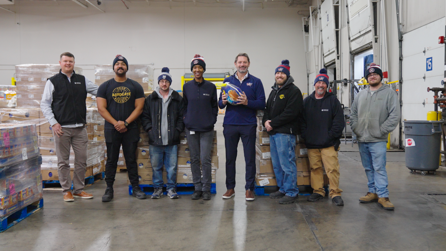 former Blue Jackets forward and current team commentator Jody Shelley stands with members of MOFC’s warehouse team at Mid-Ohio Foodbank. 