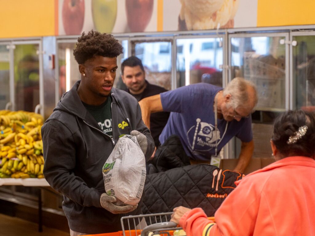 OSU football safety Caleb Downs hands out turkeys at the Mid-Ohio Market at Gantz Road on Nov. 24, 2025. 