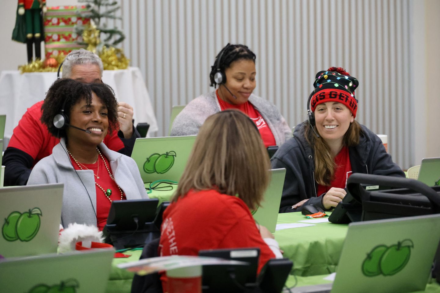 DYDD Phone bank volunteers sit together