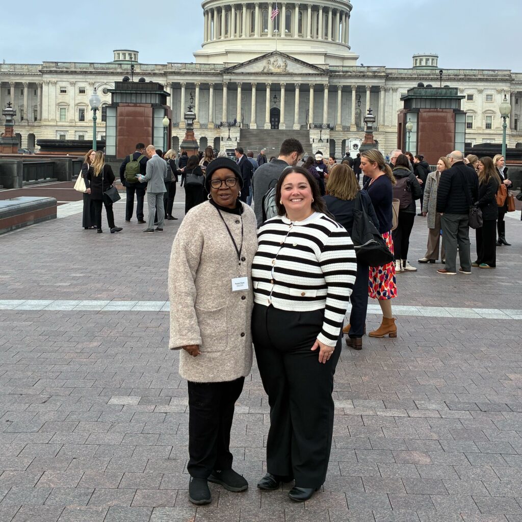Rachel Rives, customer advocate, stands with an MOFC staff member in front of the U.S. Capitol building. 